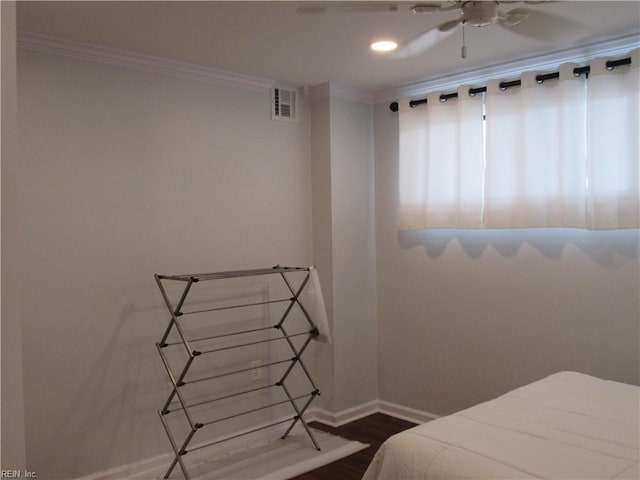 bedroom featuring ceiling fan, hardwood / wood-style floors, and ornamental molding