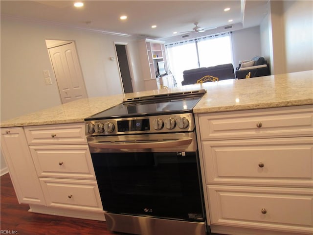 kitchen featuring light stone counters, white cabinetry, ceiling fan, and stainless steel range with electric cooktop