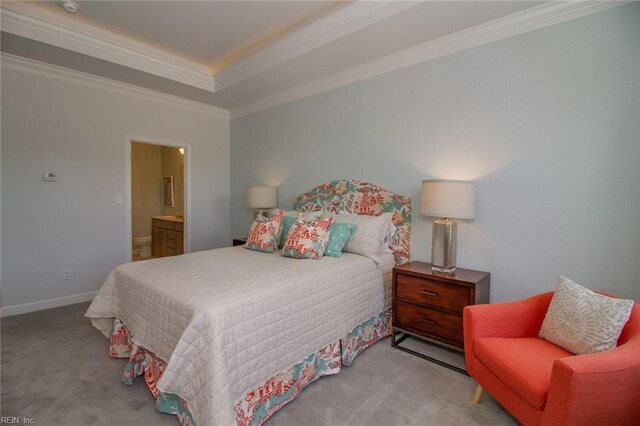 bedroom featuring ensuite bathroom, light carpet, and crown molding