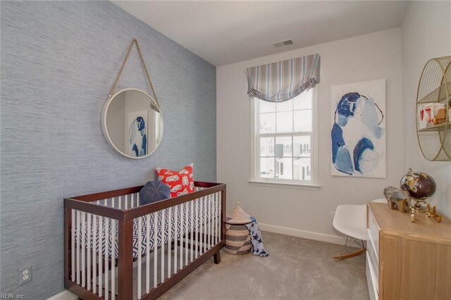 bedroom featuring carpet flooring and a crib