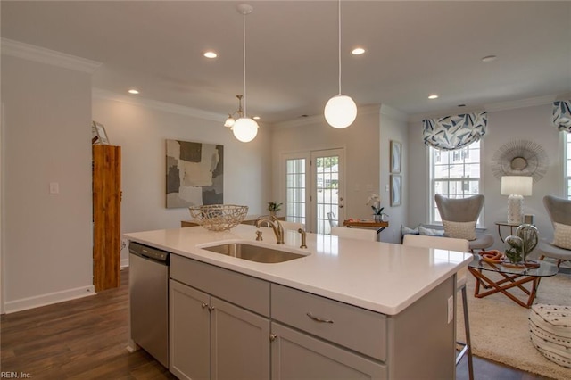 kitchen featuring stainless steel dishwasher, sink, gray cabinets, and a center island with sink