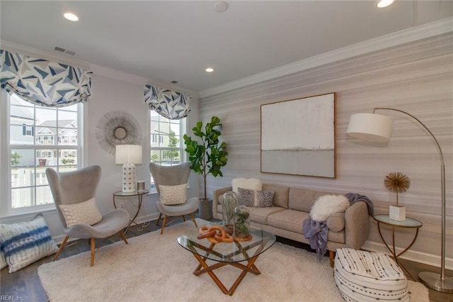 living room with hardwood / wood-style floors and crown molding