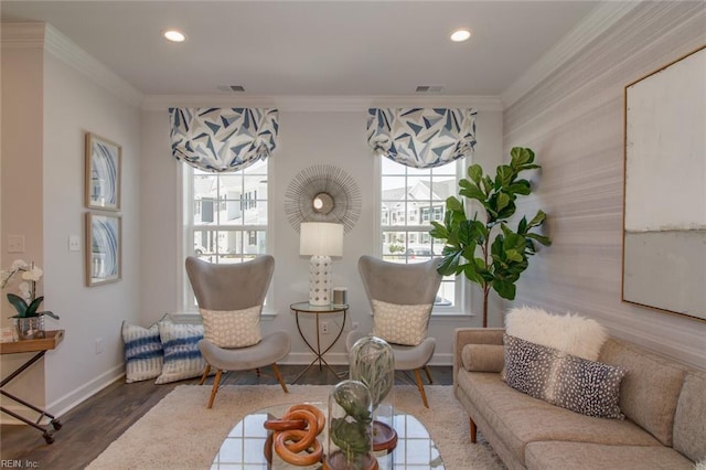 living area featuring hardwood / wood-style flooring and ornamental molding