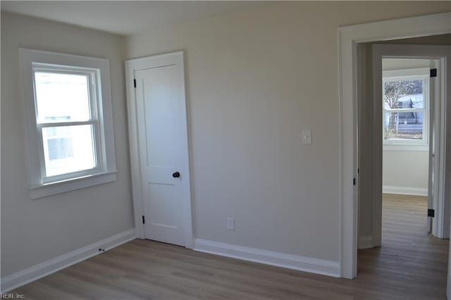 unfurnished room with wood-type flooring