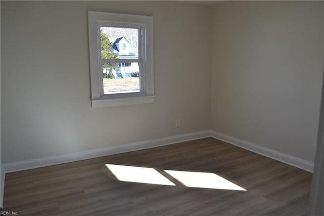 unfurnished room featuring dark wood-type flooring