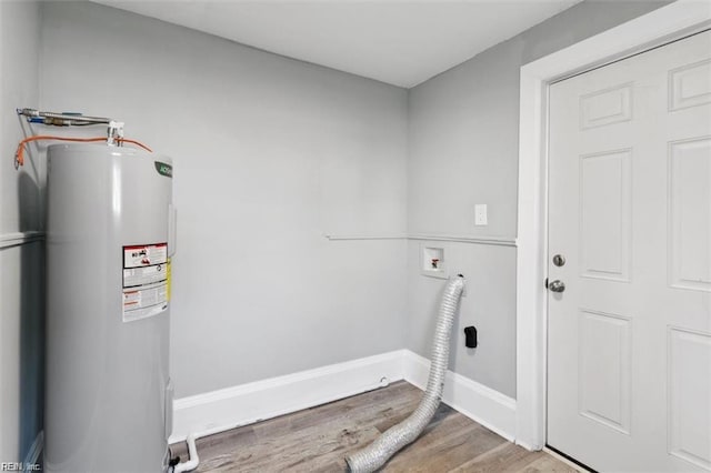 washroom featuring water heater, washer hookup, hookup for an electric dryer, and hardwood / wood-style floors