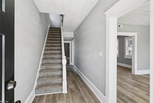 stairway featuring hardwood / wood-style floors