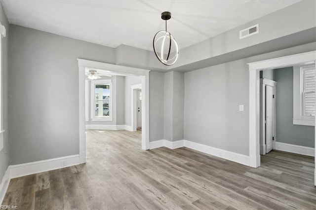 unfurnished dining area featuring ceiling fan and hardwood / wood-style floors