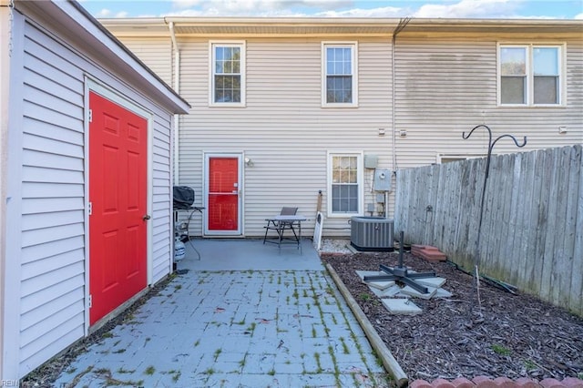 back of property with a patio area and central air condition unit