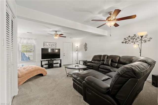 carpeted living room featuring beamed ceiling and ceiling fan