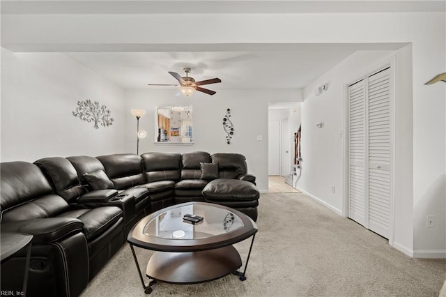 living room featuring light carpet and ceiling fan