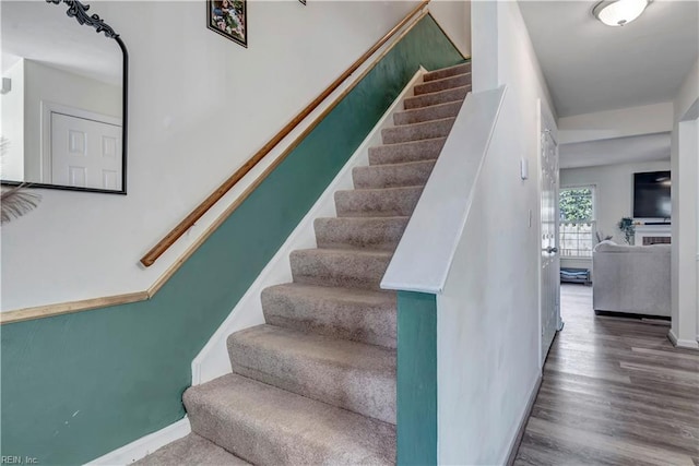 stairway featuring hardwood / wood-style floors