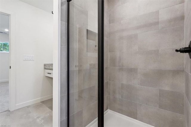 bathroom featuring tile patterned flooring and an enclosed shower