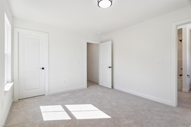 unfurnished bedroom with light carpet