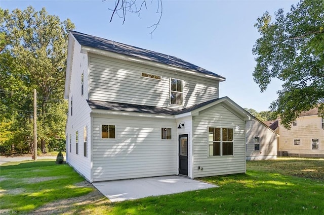 rear view of house with a yard and a patio