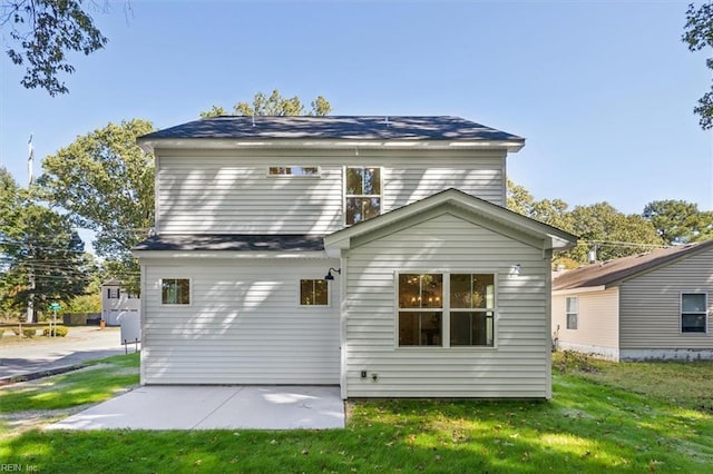 back of property with a patio area and a yard