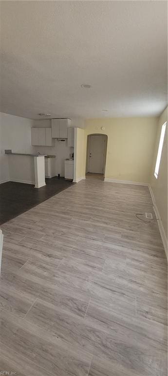 unfurnished living room featuring baseboards