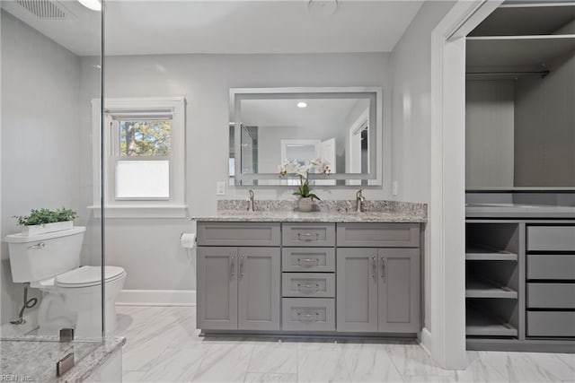 bathroom with toilet and vanity