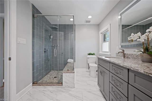 bathroom featuring toilet, a shower with shower door, and vanity