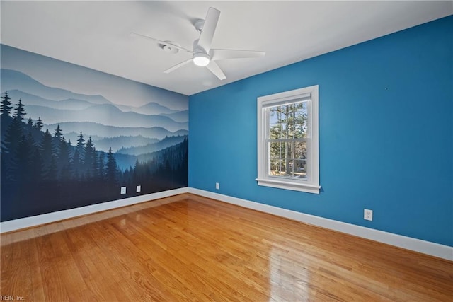 empty room with ceiling fan and hardwood / wood-style floors