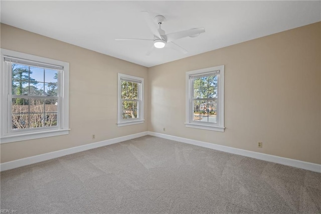 carpeted spare room featuring ceiling fan