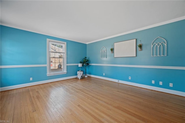 spare room featuring hardwood / wood-style floors and ornamental molding