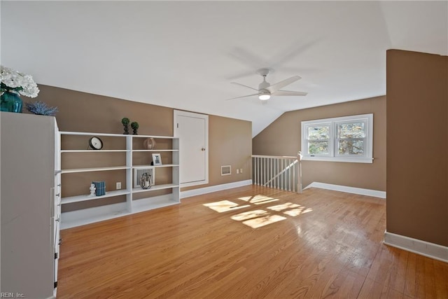 bonus room with light wood-type flooring, ceiling fan, and lofted ceiling