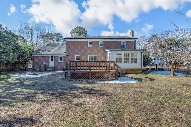 rear view of property with a deck and a yard