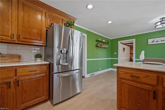 kitchen with tasteful backsplash, stainless steel refrigerator with ice dispenser, and ornamental molding