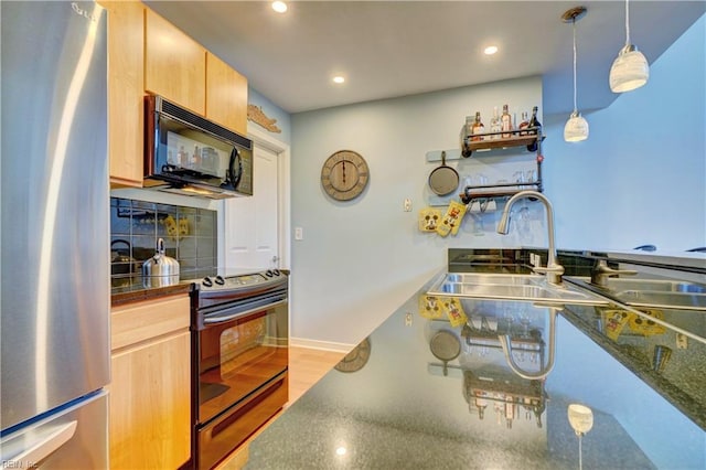 kitchen with electric stove, stainless steel fridge, light brown cabinets, and backsplash