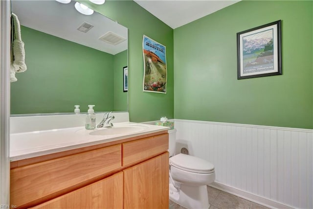 bathroom featuring vanity, toilet, and tile patterned flooring