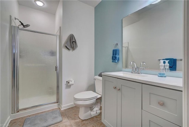 bathroom with vanity, toilet, tile patterned floors, and walk in shower