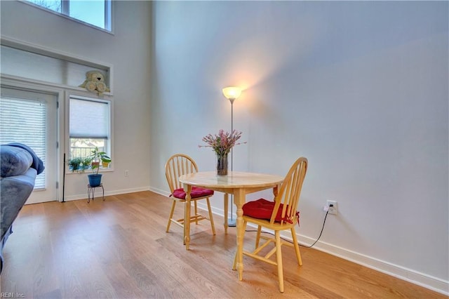 dining space with light hardwood / wood-style flooring