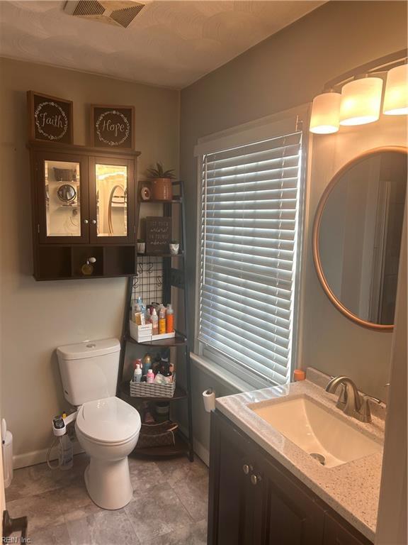 bathroom featuring toilet and vanity