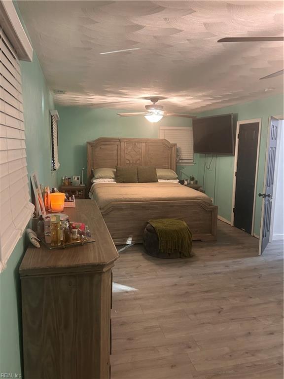 bedroom with ceiling fan and light hardwood / wood-style flooring