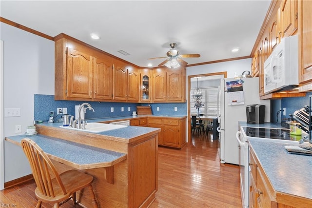 kitchen featuring crown molding, white appliances, sink, and light hardwood / wood-style flooring