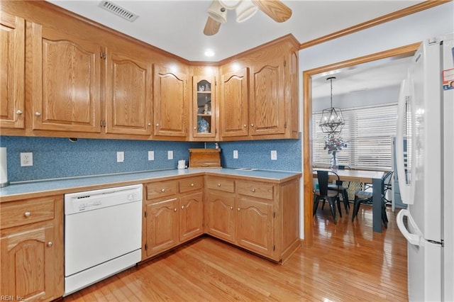 kitchen featuring tasteful backsplash, white appliances, light hardwood / wood-style floors, and ceiling fan