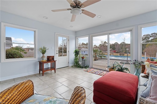 sunroom / solarium featuring ceiling fan