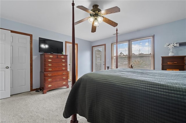 bedroom with ceiling fan and light carpet