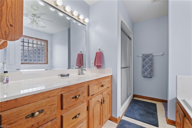 bathroom featuring vanity, ceiling fan, and a shower with shower door