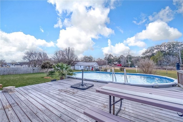 view of pool with a deck and a lawn