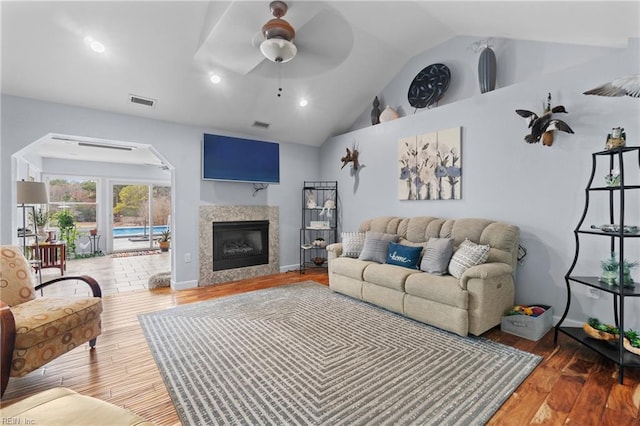 living room featuring lofted ceiling, dark hardwood / wood-style floors, and ceiling fan