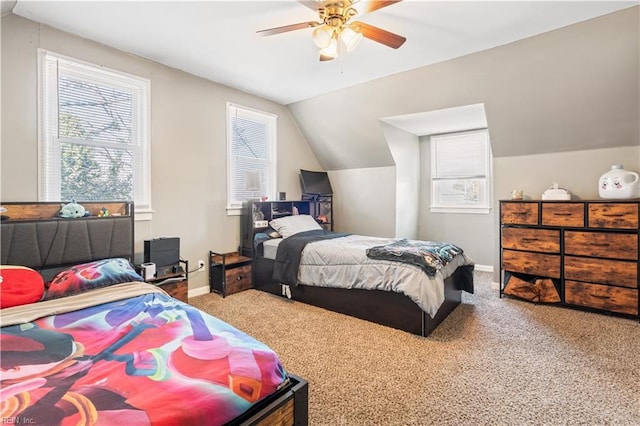 carpeted bedroom with ceiling fan and lofted ceiling