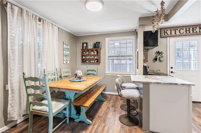 dining space with hardwood / wood-style floors and crown molding