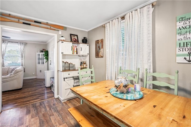 dining area featuring dark hardwood / wood-style floors and crown molding