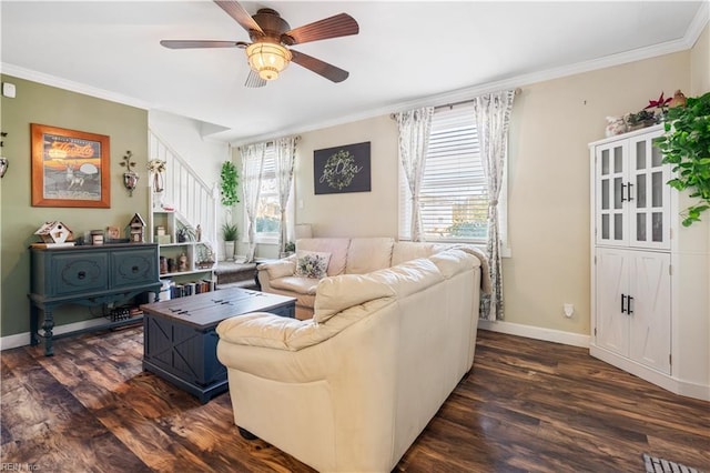 living room with ceiling fan, dark wood-type flooring, plenty of natural light, and ornamental molding