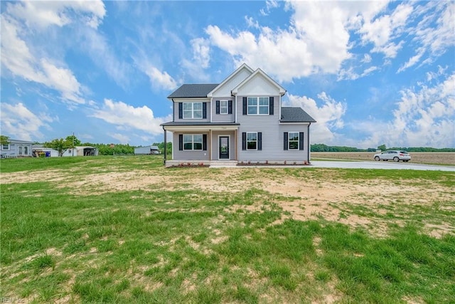 view of front of property featuring a water view and a front lawn