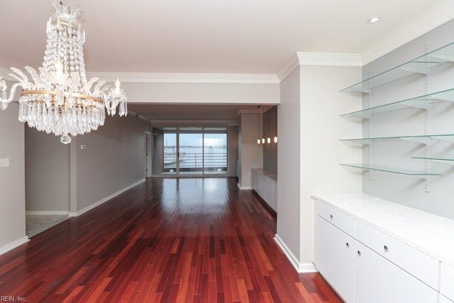 unfurnished dining area featuring crown molding, dark wood-type flooring, and a notable chandelier