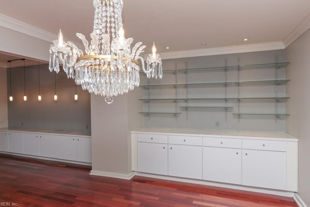 unfurnished dining area with dark hardwood / wood-style flooring, ornamental molding, and a chandelier