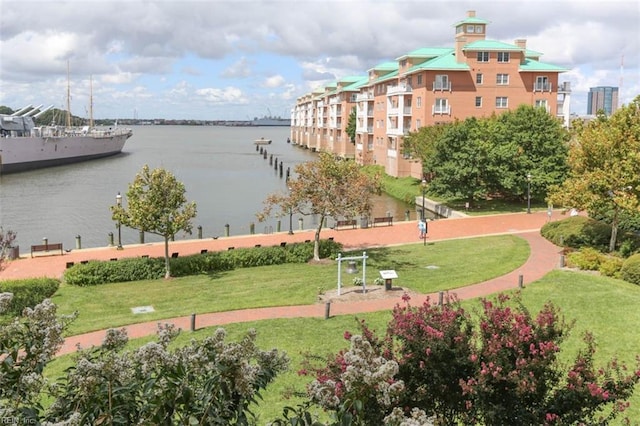 view of community featuring a water view and a yard